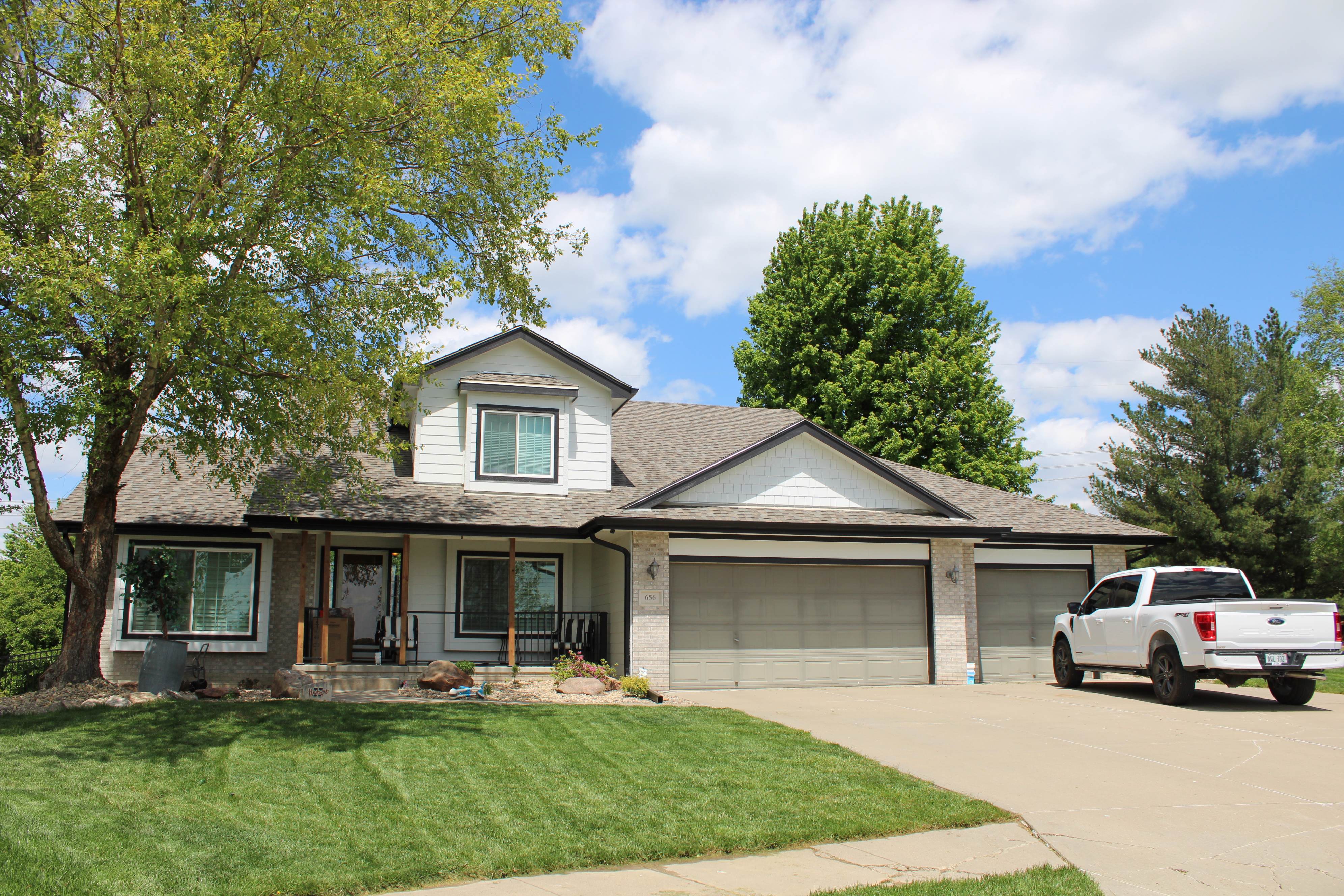 Two-story Omaha home with seamless gutters and a covered front porch